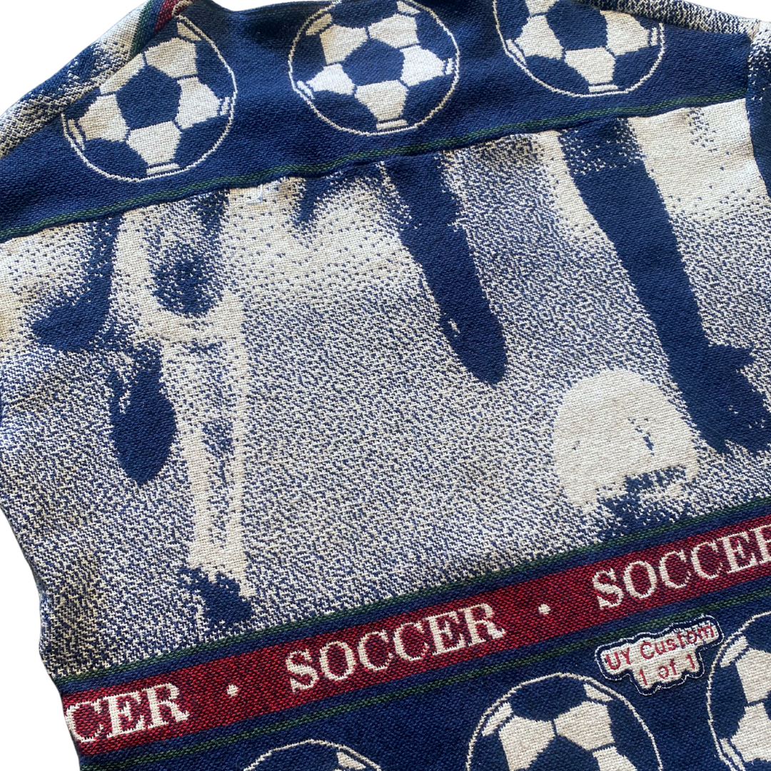Unapologetic Youth XL football T-shirt featuring bold soccer-themed design on white fabric.