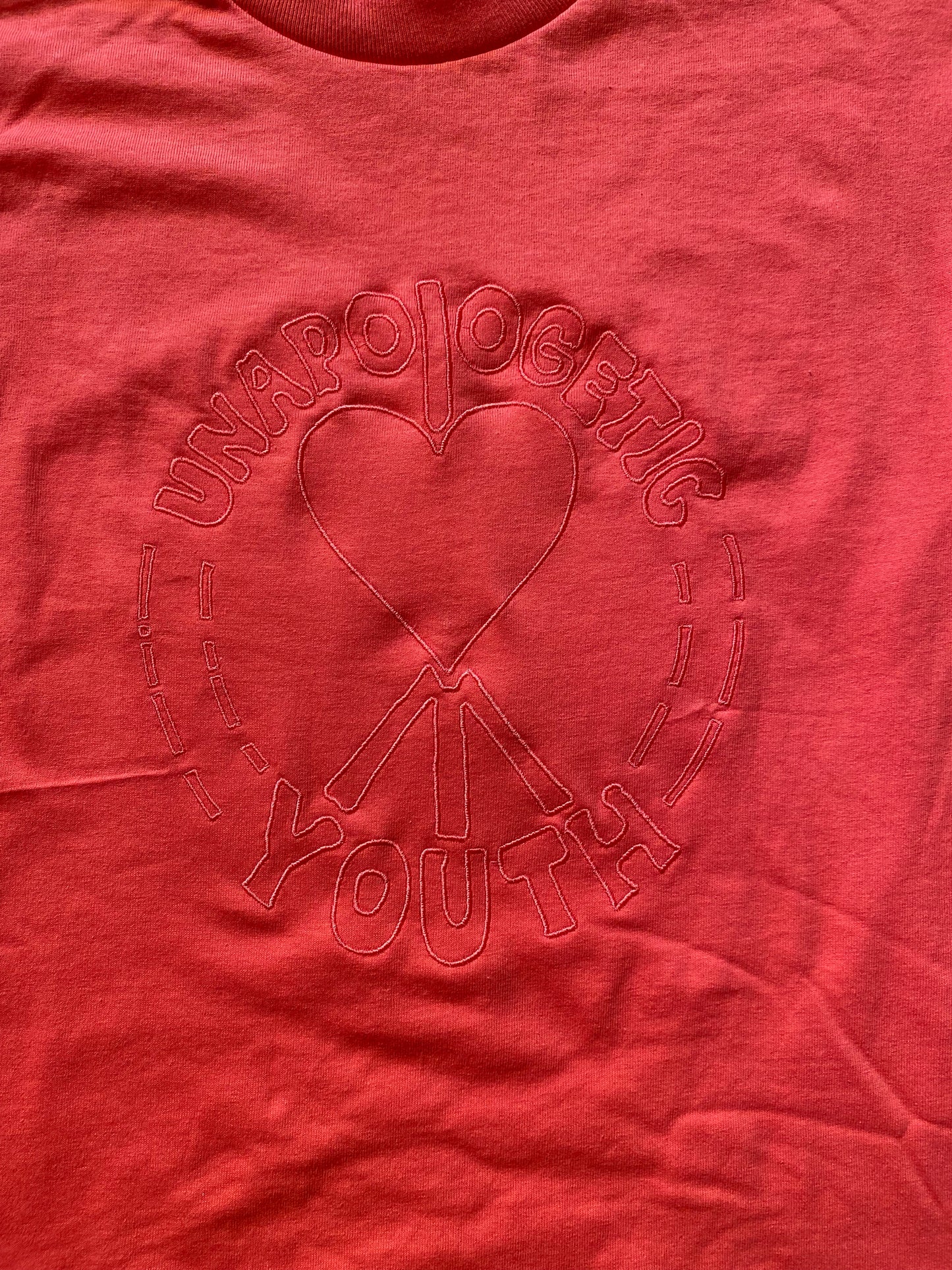 Small Unapologetic Youth T-shirt in white, featuring a comfortable fit and casual style, shown flat on a plain background.