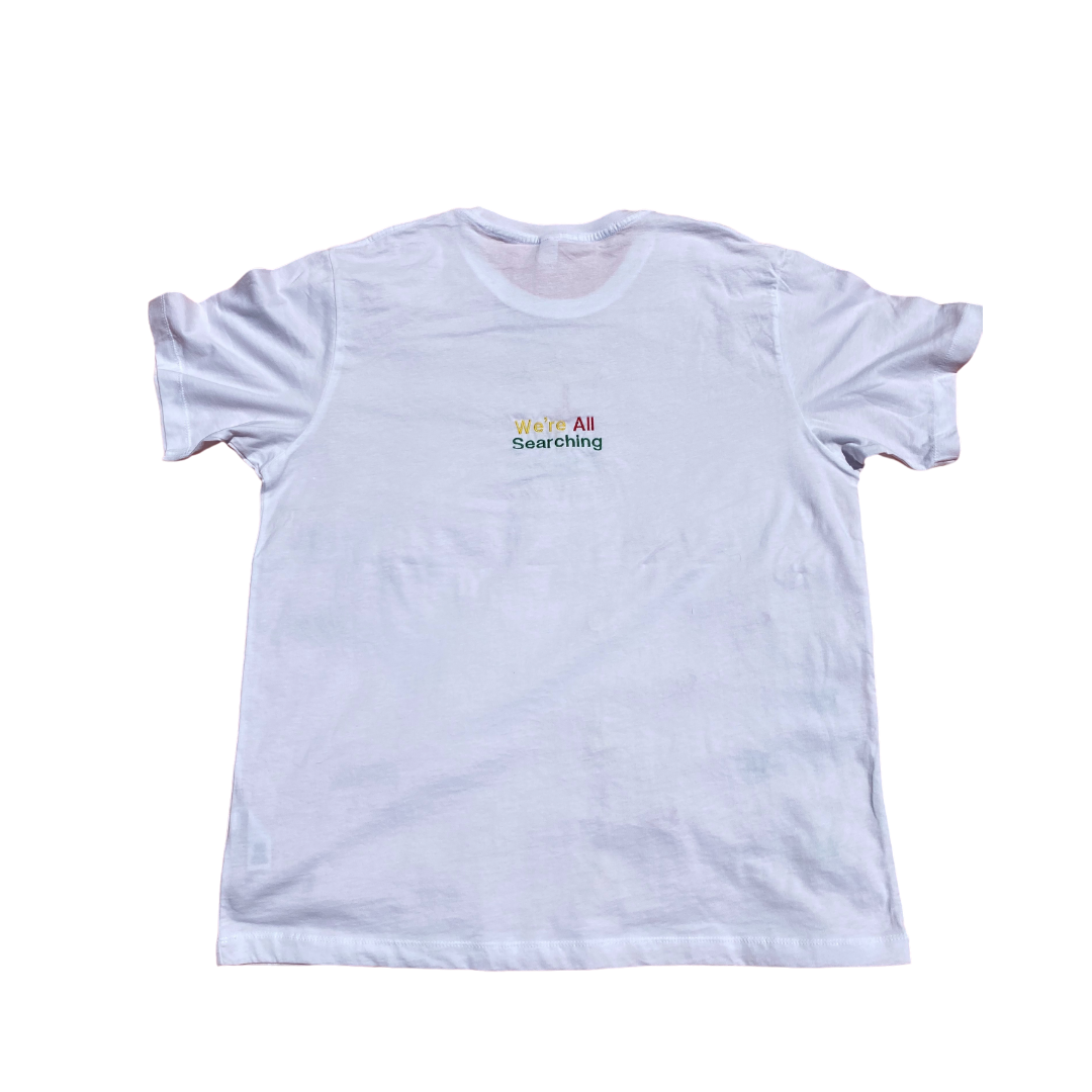 Unapologetic Youth Rasta Mon' T-shirt featuring a colorful Rastafarian-inspired graphic design on the back.