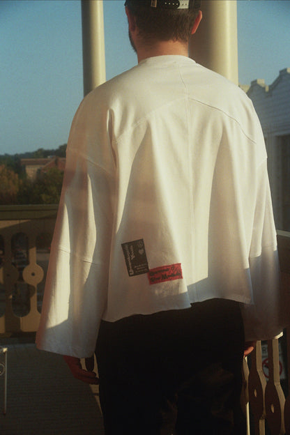 Unapologetic Youth INSFBD flared long sleeve shirt with fitted cuffs and a relaxed fit, shown in a neutral color.