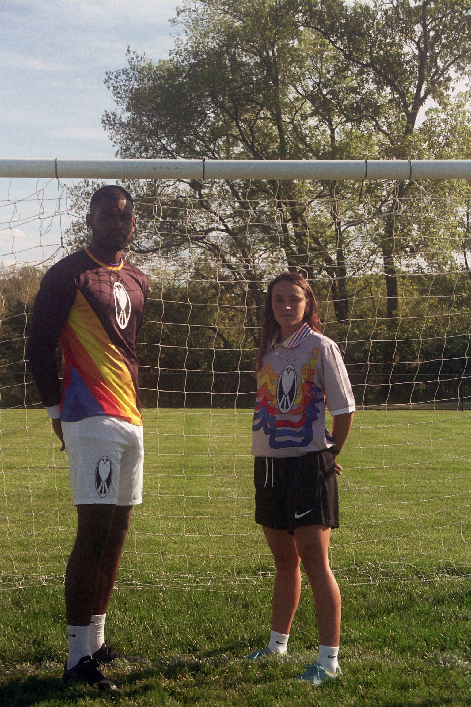 Unapologetic Youth UYFC Home jersey, navy and white design, featuring team logo and athletic fit, displayed on a hanger.