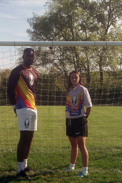 Unapologetic Youth UYFC Home jersey, navy and white design, featuring team logo and athletic fit, displayed on a hanger.