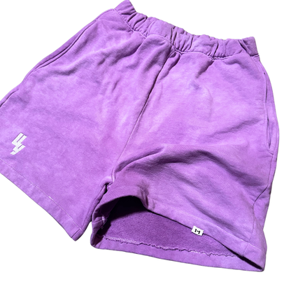 Unapologetic Youth Purple Haze sweatshorts with a comfortable fit and vibrant purple color, shown on a model.