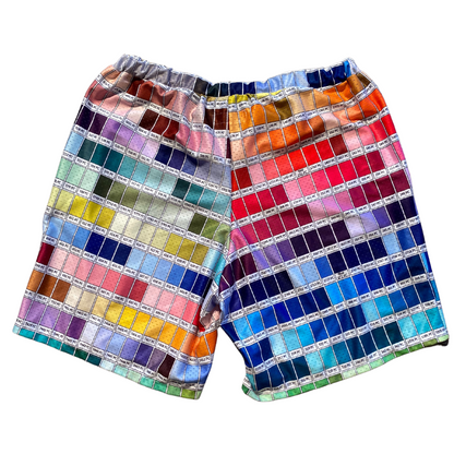 Unapologetic Youth color wheel shorts featuring vibrant multicolor fabric with a relaxed fit and casual style.