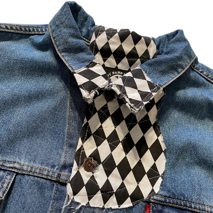 Unapologetic Youth Torn large/XL denim jacket with distressed details and classic fit, shown hanging on a wooden background.
