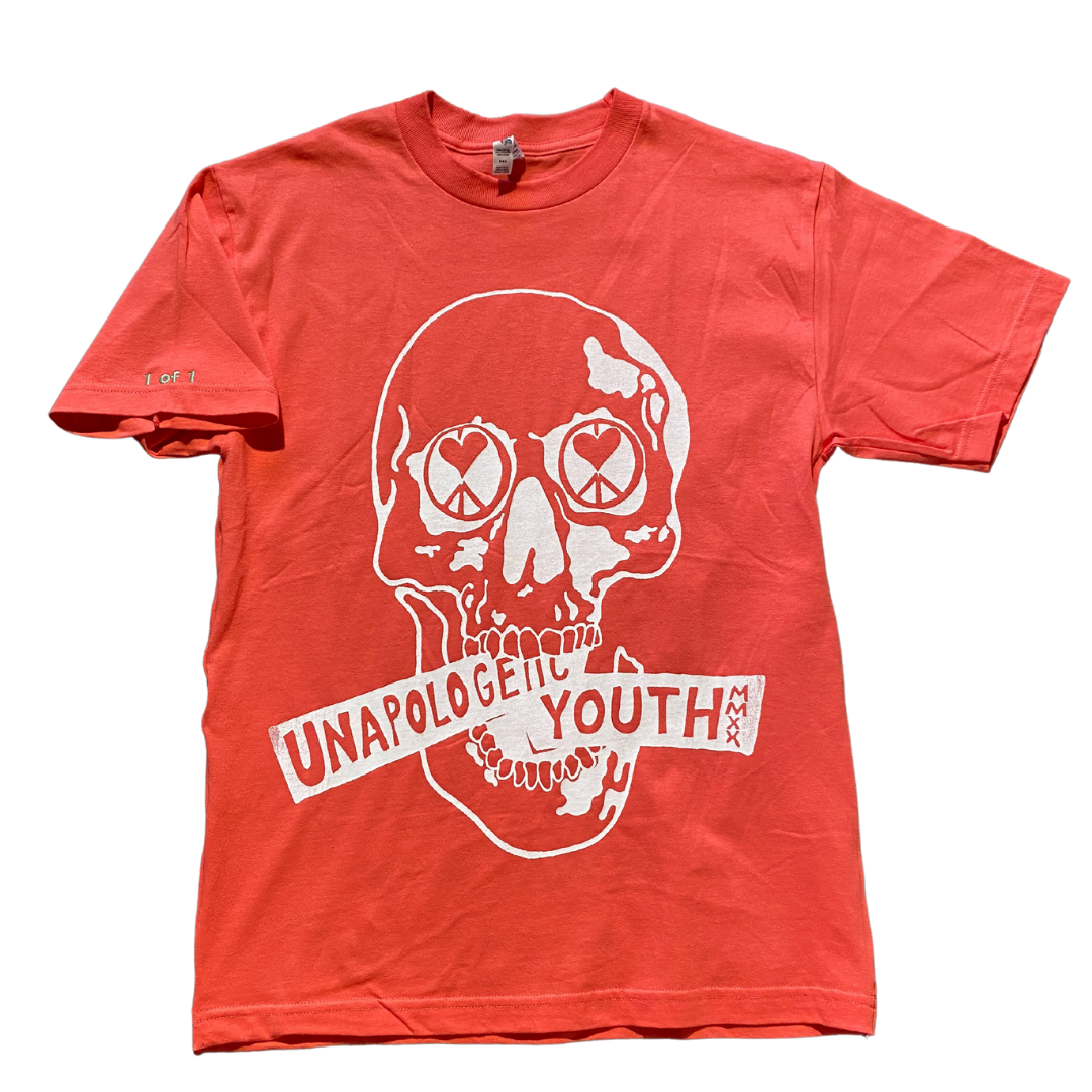 Hot pink Unapologetic Youth T-shirt displayed on a hanger, showcasing the vibrant color and casual style.
