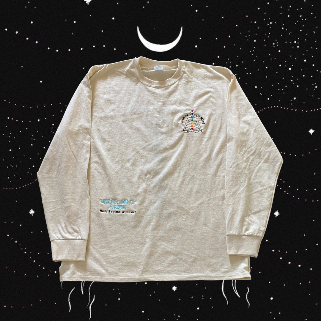 Unapologetic Youth Inner Awakening long sleeve shirt featuring a bold graphic design on black fabric.