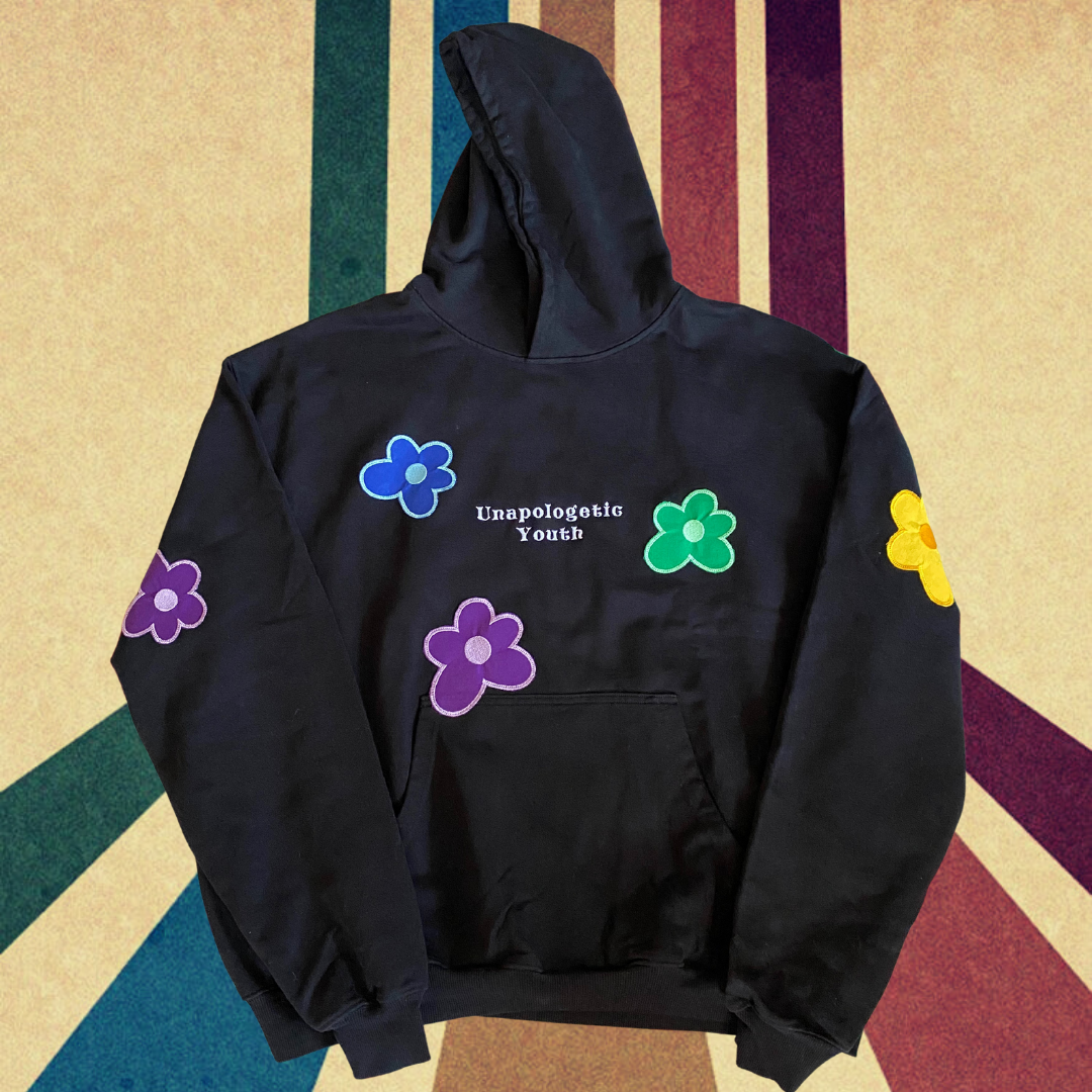 Unapologetic Youth Hippie Dreams hoodie featuring colorful bohemian-inspired graphic design on soft fabric.