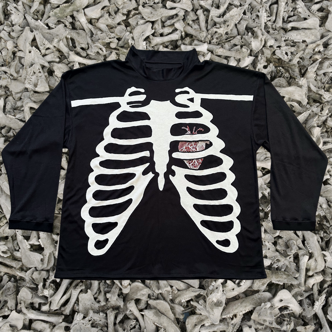 Unapologetic Youth long sleeve shirt with a bone graphic design on the front, casual and stylish for everyday wear.