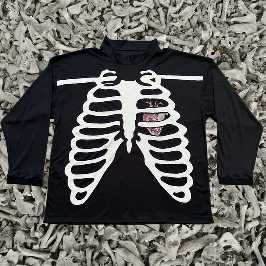 Unapologetic Youth long sleeve shirt with a bone graphic design on the front, casual and stylish for everyday wear.