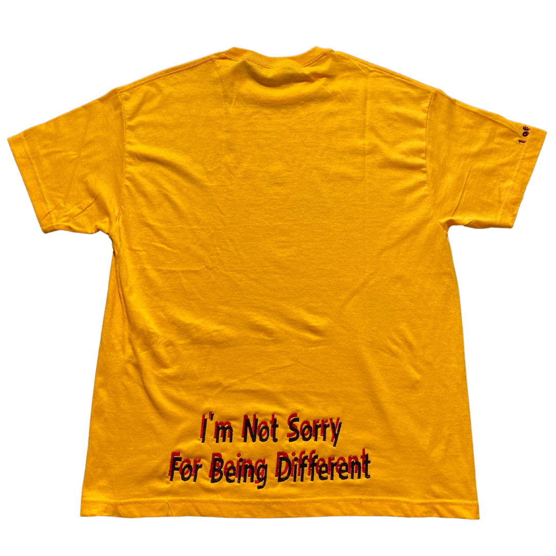 Golden yellow Unapologetic Youth T-shirt displayed flat, showcasing its color and casual fit with soft fabric texture.