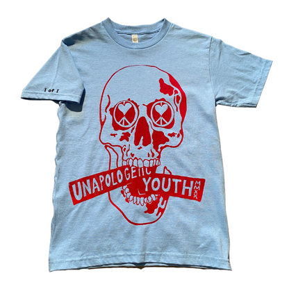 Baby blue Unapologetic Youth T-shirt laid flat, showcasing its soft fabric and simple design for kids or casual wear.
