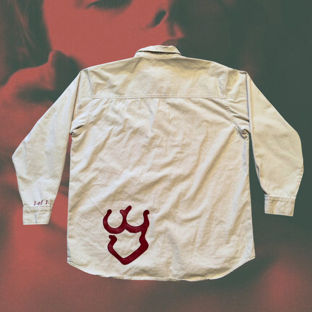 Unapologetic Youth button-down shirt featuring a minimalist design, displayed on a hanger against a plain background.