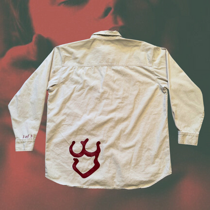Unapologetic Youth button-down shirt featuring a minimalist design, displayed on a hanger against a plain background.