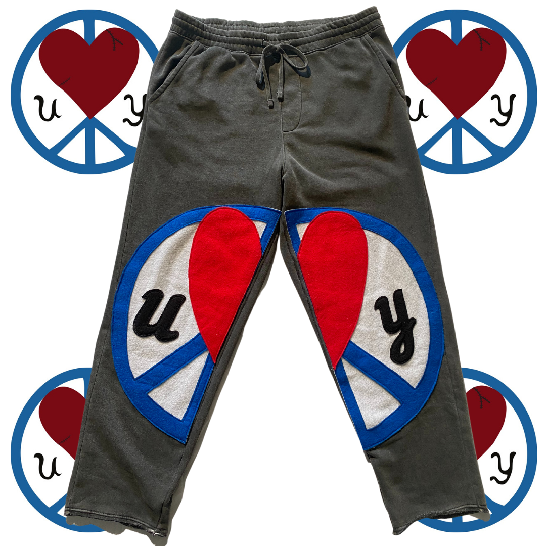 Unapologetic Youth Split Logo sweatpants with bold logo detail, black athletic joggers with relaxed fit and drawstring waist