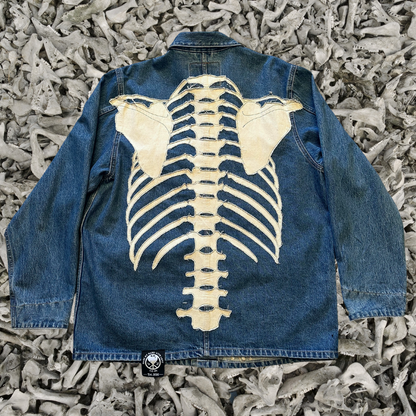 Unapologetic Youth denim jean jacket with distressed bones design, featuring classic collar and button closure for a casual, stylish look.
