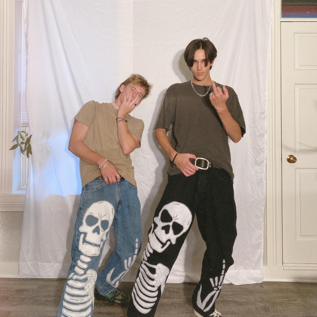 Blue denim jeans from Unapologetic Youth x Levi, featuring classic fit and distressed details, shown laid flat.