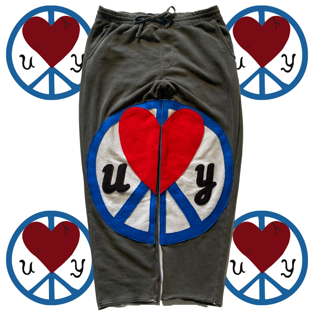 Unapologetic Youth Split Logo sweatpants with bold logo design on gray cotton athletic joggers.