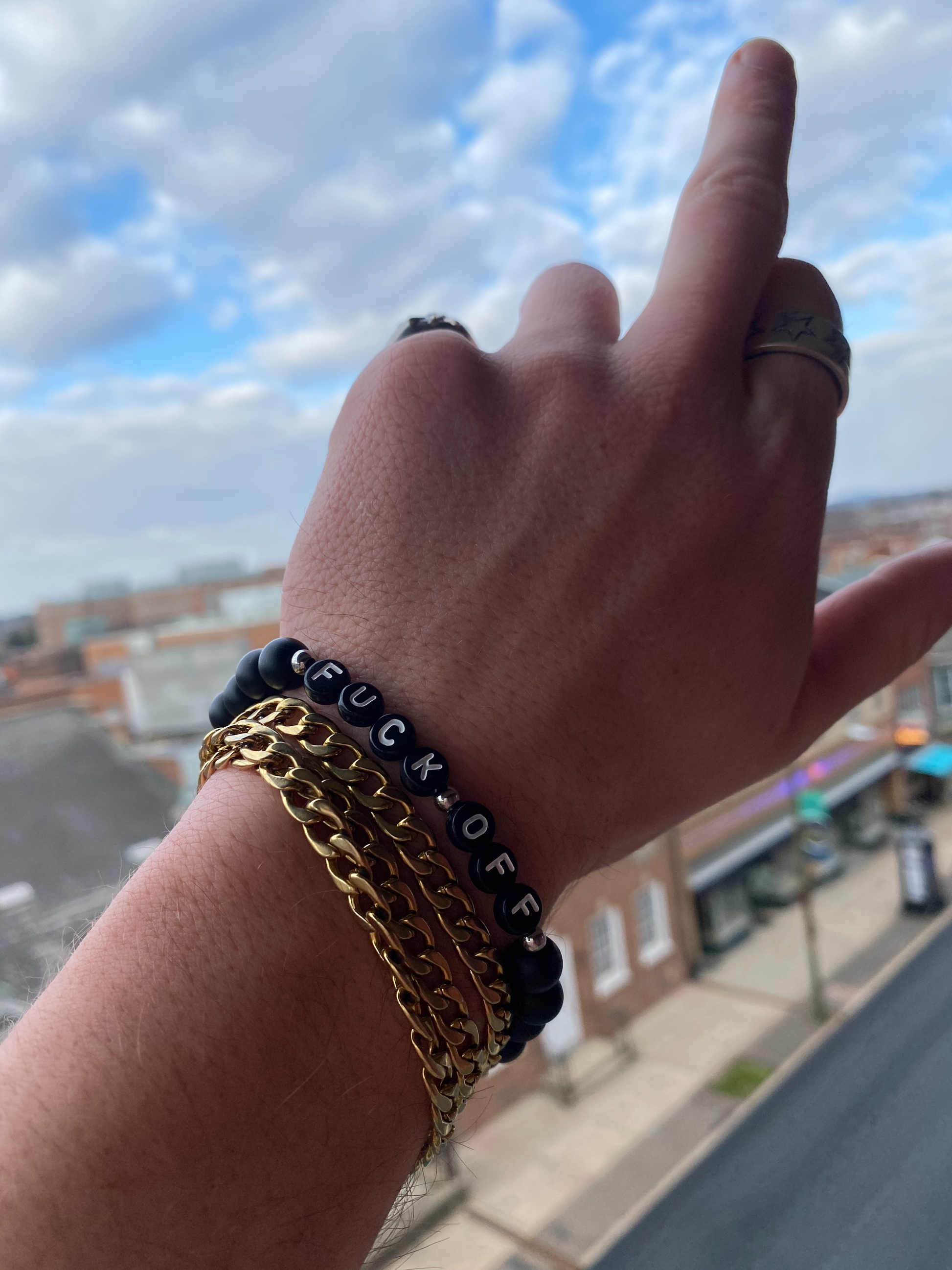 Unapologetic Youth Fuck Off bracelet with bold black band and metallic lettering, stylish accessory for making a statement.