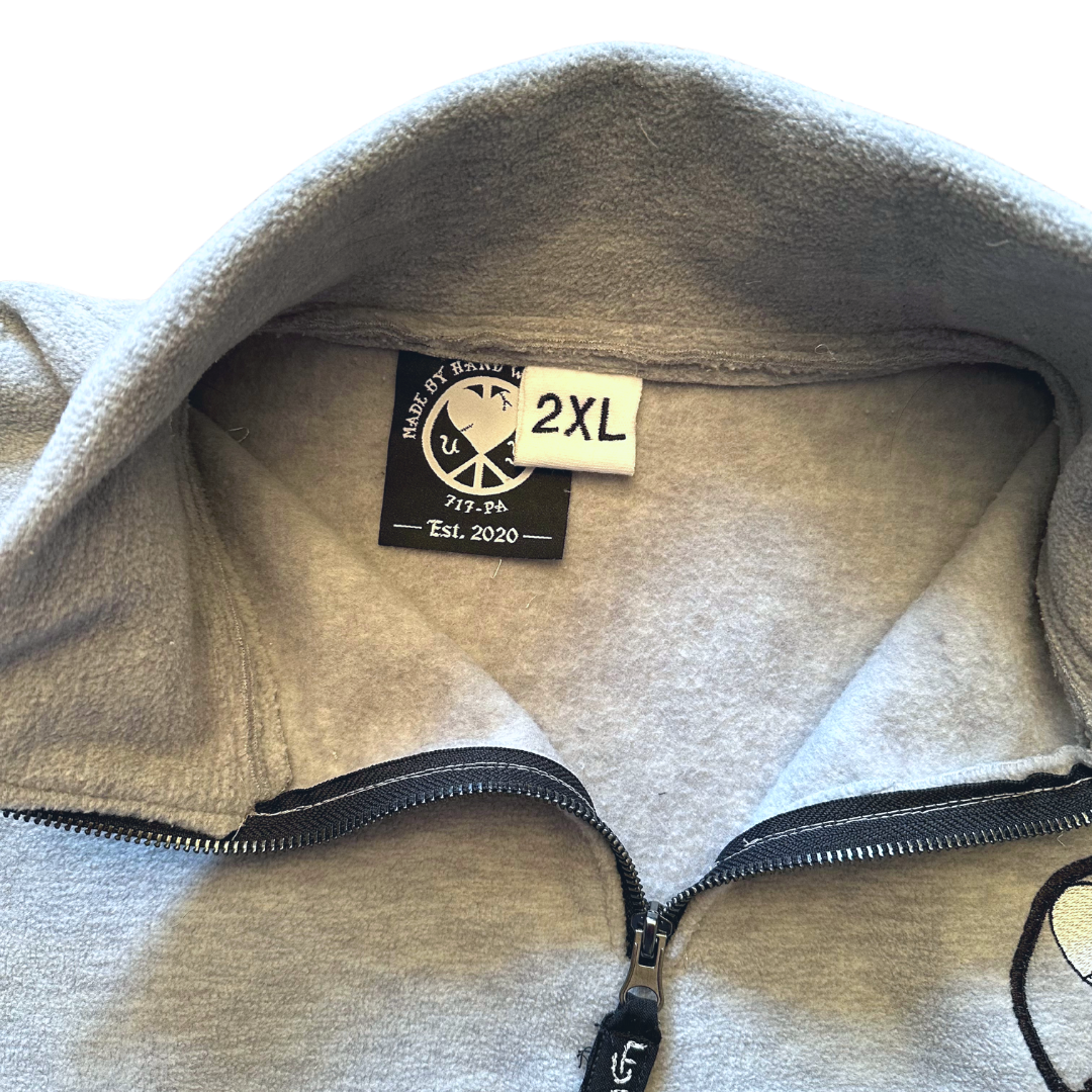 Unapologetic Youth fleece jacket, part of Misc. Pt. 2, featuring soft fabric and casual style in a close-up view.