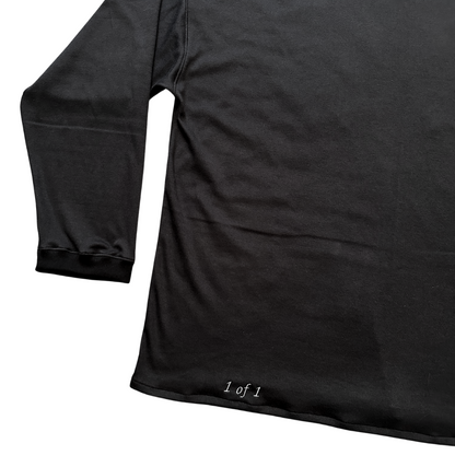 Unapologetic Youth long sleeve Bones shirt featuring a stylish bone graphic design on a black fabric background.