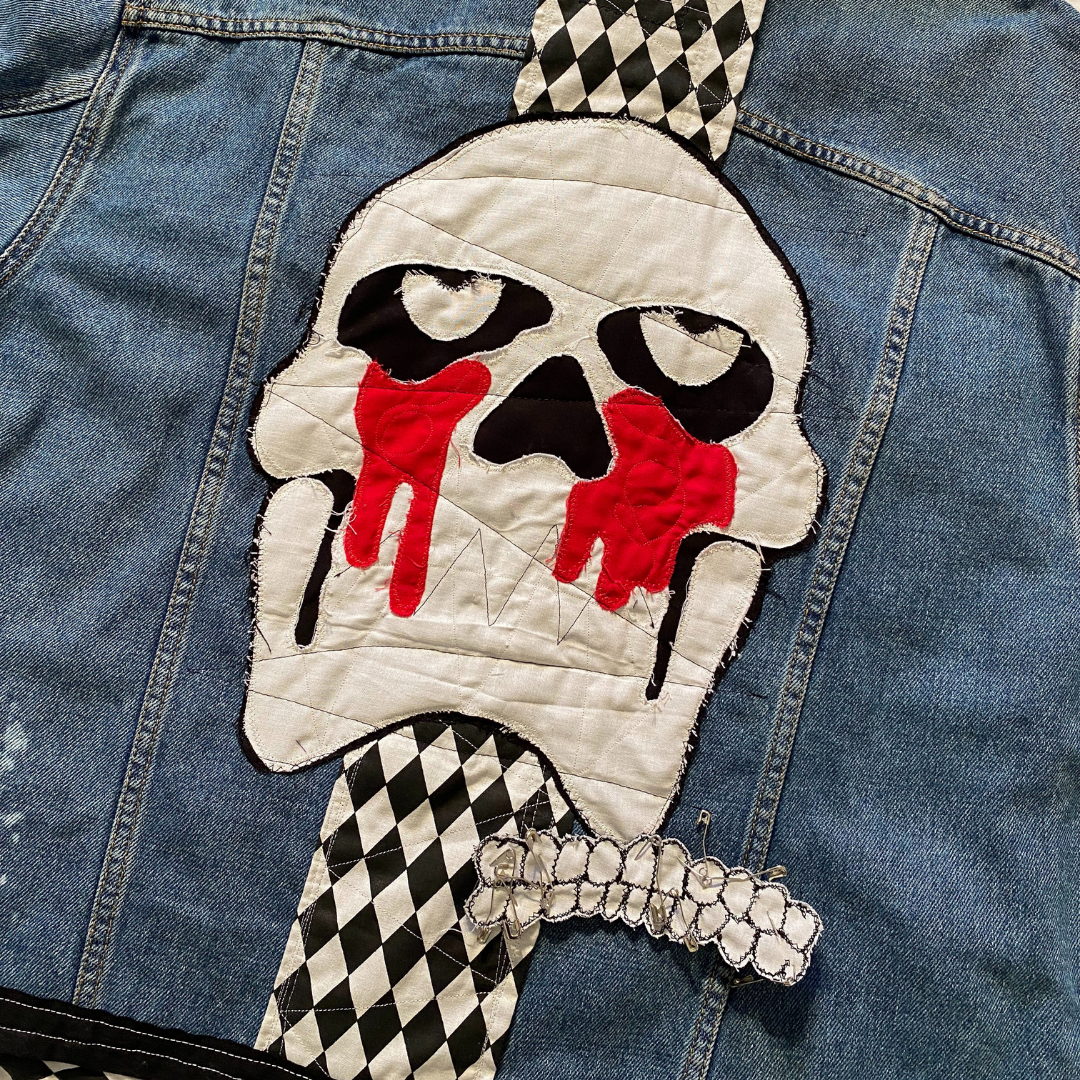 Unapologetic Youth Torn large/XL denim jacket featuring distressed details and classic fit, showcased on a plain background.