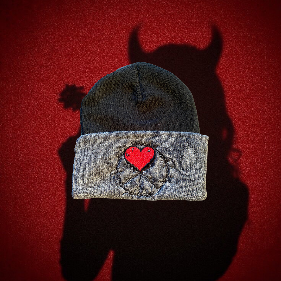 Unapologetic Youth Cold World black and gray beanie with bold graphic design, cozy knit fabric, and folded brim.