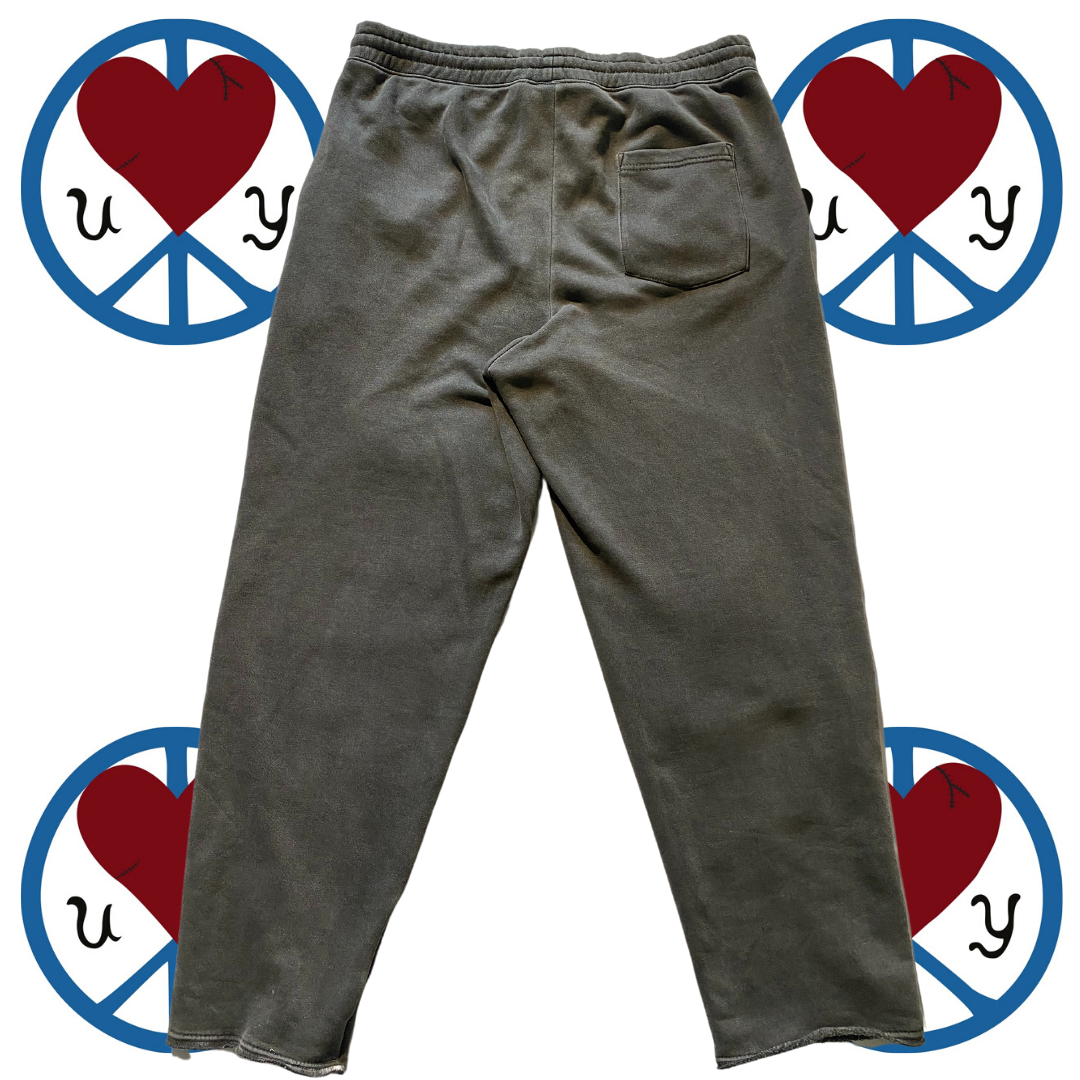 Unapologetic Youth Split Logo sweatpants with front pockets and tapered cuffs, made from soft, comfortable fabric.