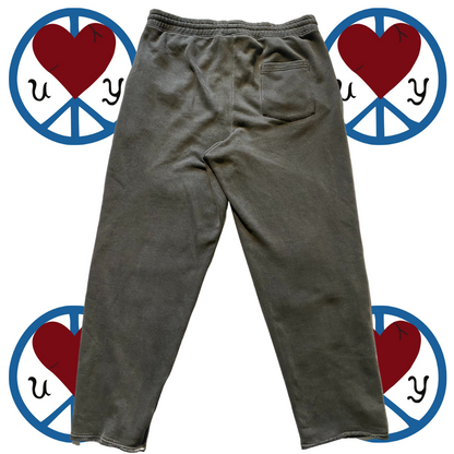 Unapologetic Youth Split Logo sweatpants with front pockets and tapered cuffs, made from soft, comfortable fabric.