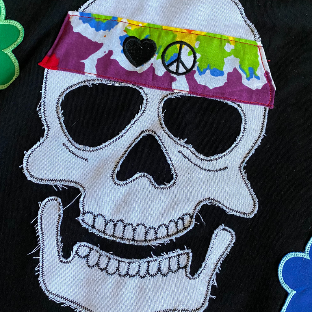 Unapologetic Youth Hippie Dreams hoodie displayed on a hanger, featuring colorful, bohemian-inspired design and soft fabric.