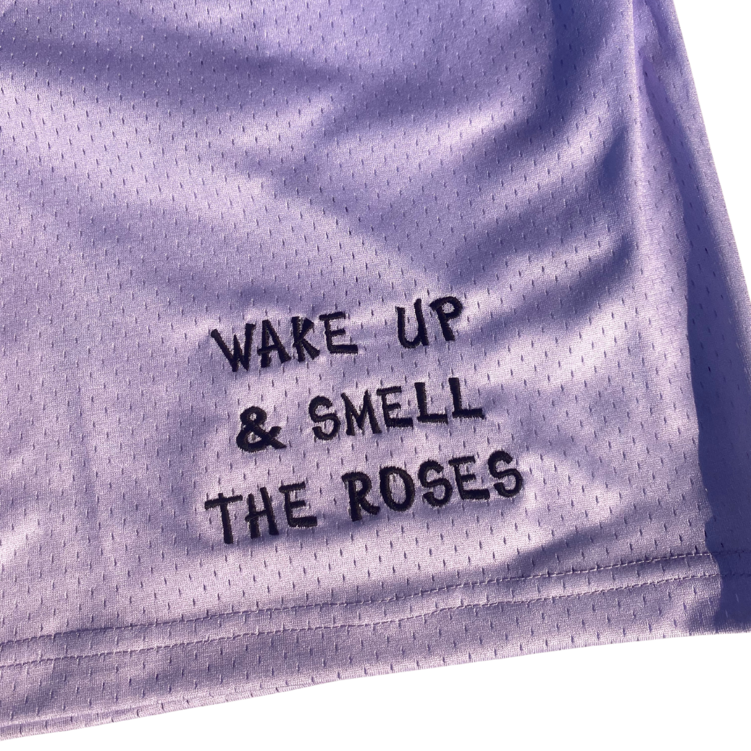 Unapologetic Youth Rose City shorts in vibrant pink with casual fit, displayed on a hanger.