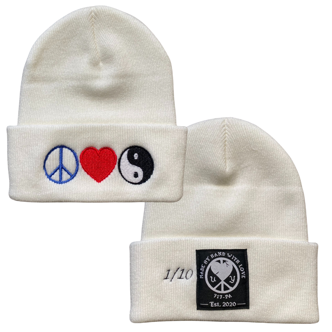 Unapologetic Youth Peace, Love, and Harmony beanie with colorful embroidered text on soft knit fabric.