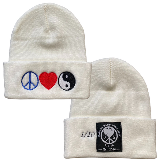 Unapologetic Youth Peace, Love, and Harmony beanie with colorful embroidered text on soft knit fabric.