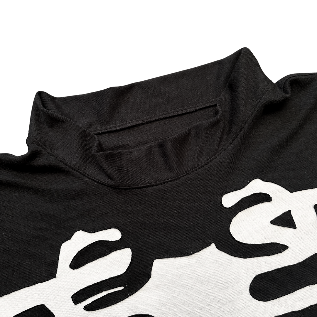 Unapologetic Youth long sleeve bones graphic t-shirt, black with white bone design, casual streetwear top for everyday wear