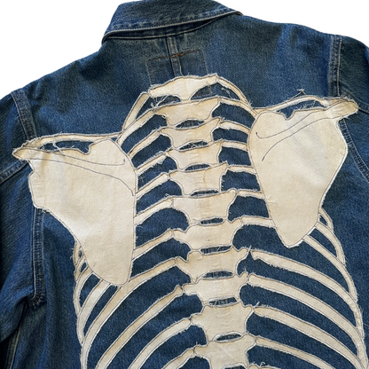 Unapologetic Youth denim jean jacket with distressed bones design, long sleeves, classic collar, and button closure.