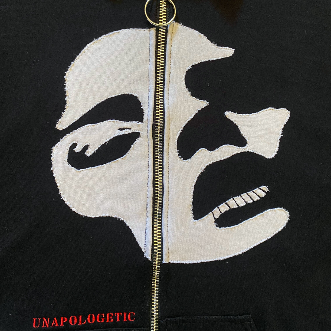 Unapologetic Youth Faces sweatshirt featuring two colorful face designs on soft cotton fabric.