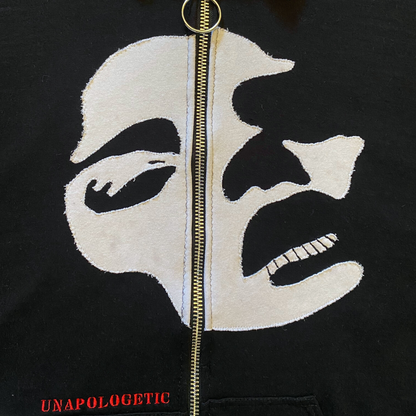 Unapologetic Youth Faces sweatshirt featuring two colorful face designs on soft cotton fabric.