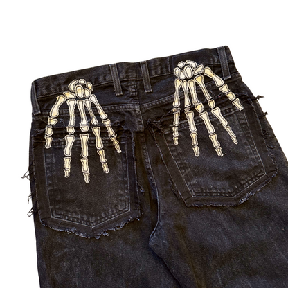 Unapologetic Youth Bones jeans, showing the front view with distressed detailing and classic five-pocket design on denim fabric.