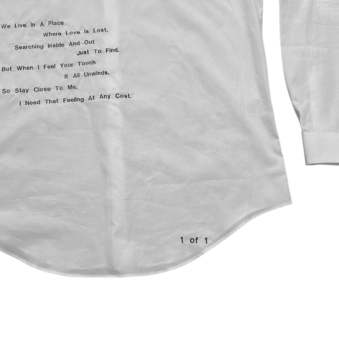 Unapologetic Youth button-down shirt featuring a face print design, shown in a close-up of the fabric and collar detail.