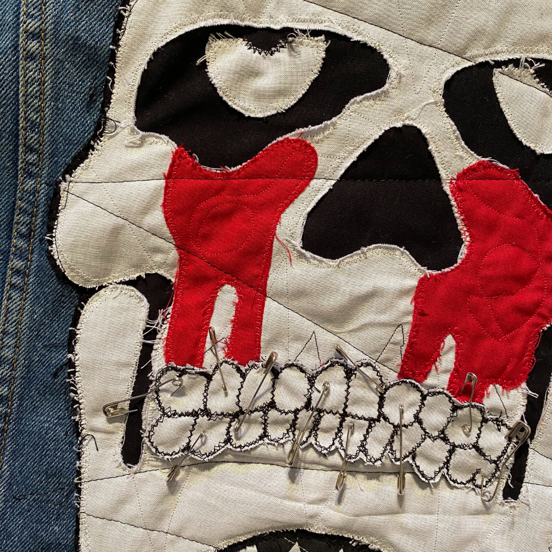 Unapologetic Youth Torn large/XL denim jacket with distressed details and classic denim styling, displayed on a hanger.