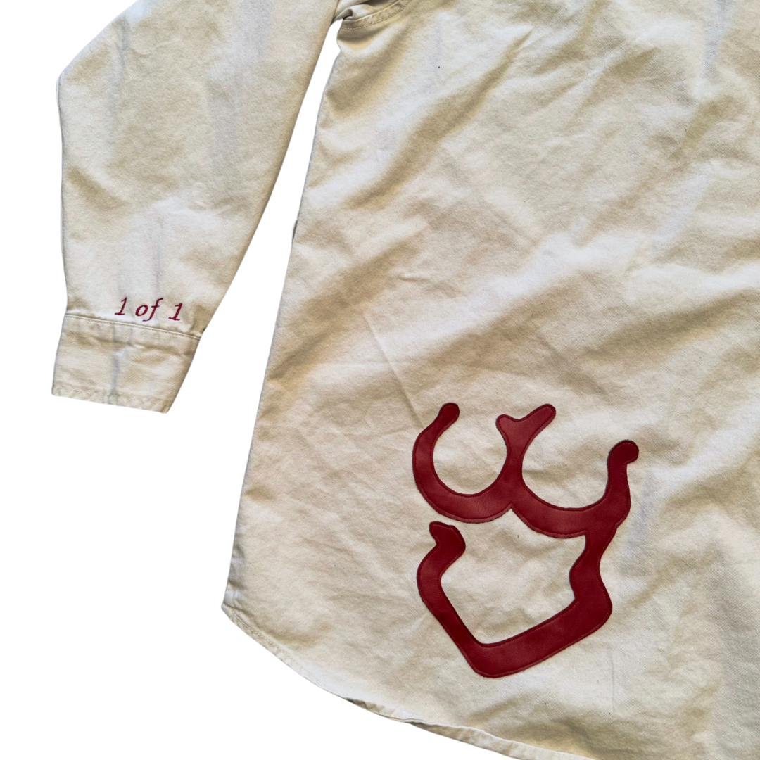 Unapologetic Youth button-down shirt featuring a nudity-themed graphic design, displayed flat with collar and button details.