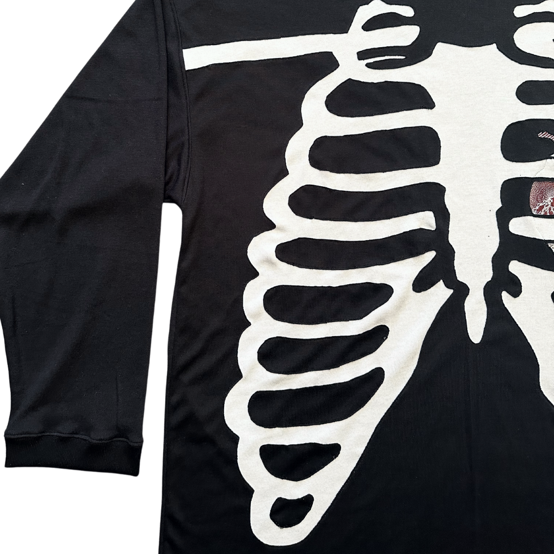 Unapologetic Youth long sleeve Bones shirt featuring a graphic design with bones, black fabric, and casual fit.