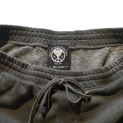 Unapologetic Youth Split Logo sweatpants with modern design, soft fabric, and comfortable fit, shown on a plain background.
