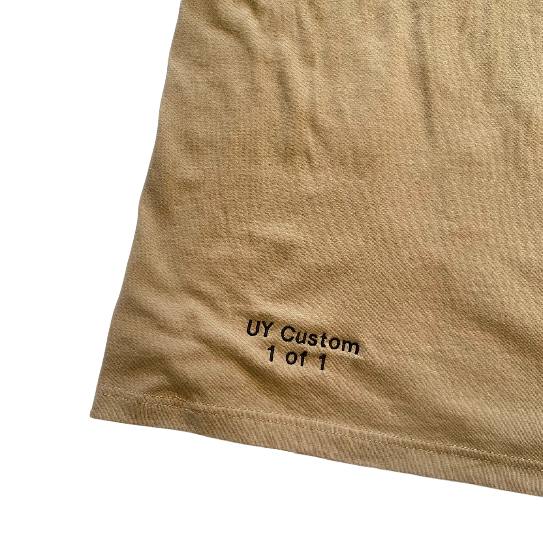 Large natural-colored T-shirt by Unapologetic Youth displayed on a plain background.