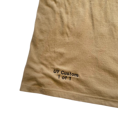 Large natural-colored T-shirt by Unapologetic Youth displayed on a plain background.