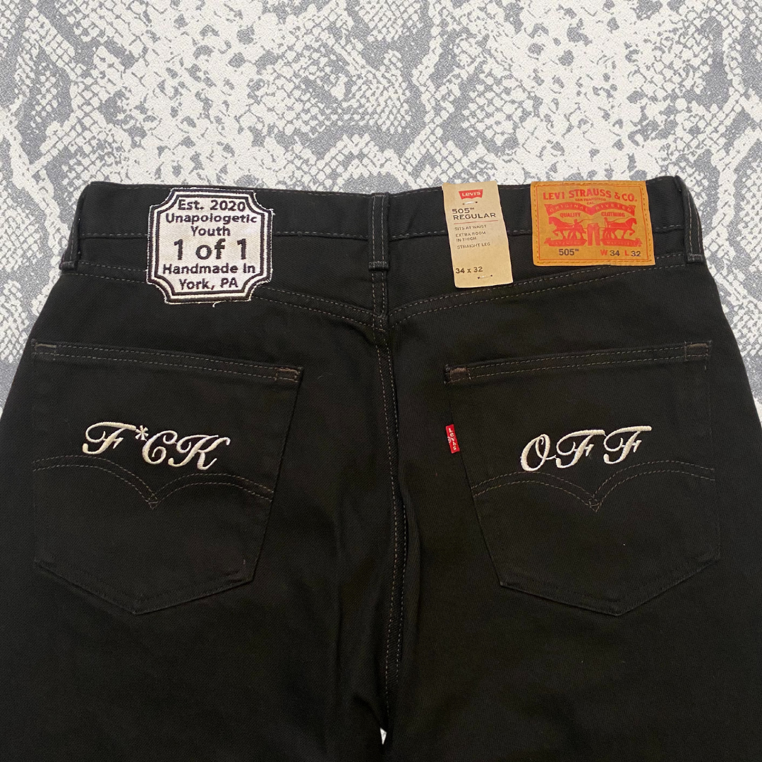 Unapologetic Youth "To The Bone" jeans showing distressed denim with frayed hems and classic five-pocket design.