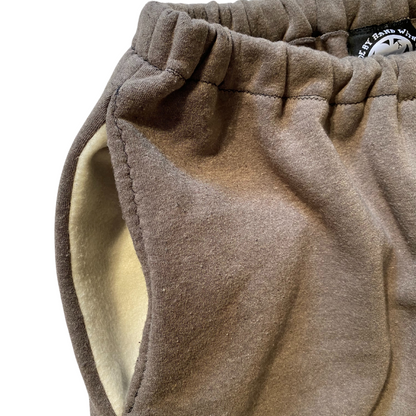 Unapologetic Youth F*cked medium sweatpants with bold black text, relaxed fit, soft fabric, and elastic waistband.