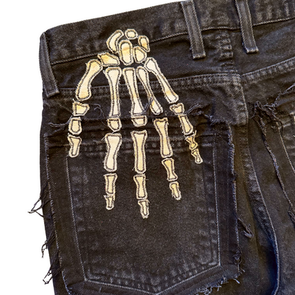 Unapologetic Youth Bones jeans, stylish denim pants with distressed details, shown from the front in a casual fashion pose.