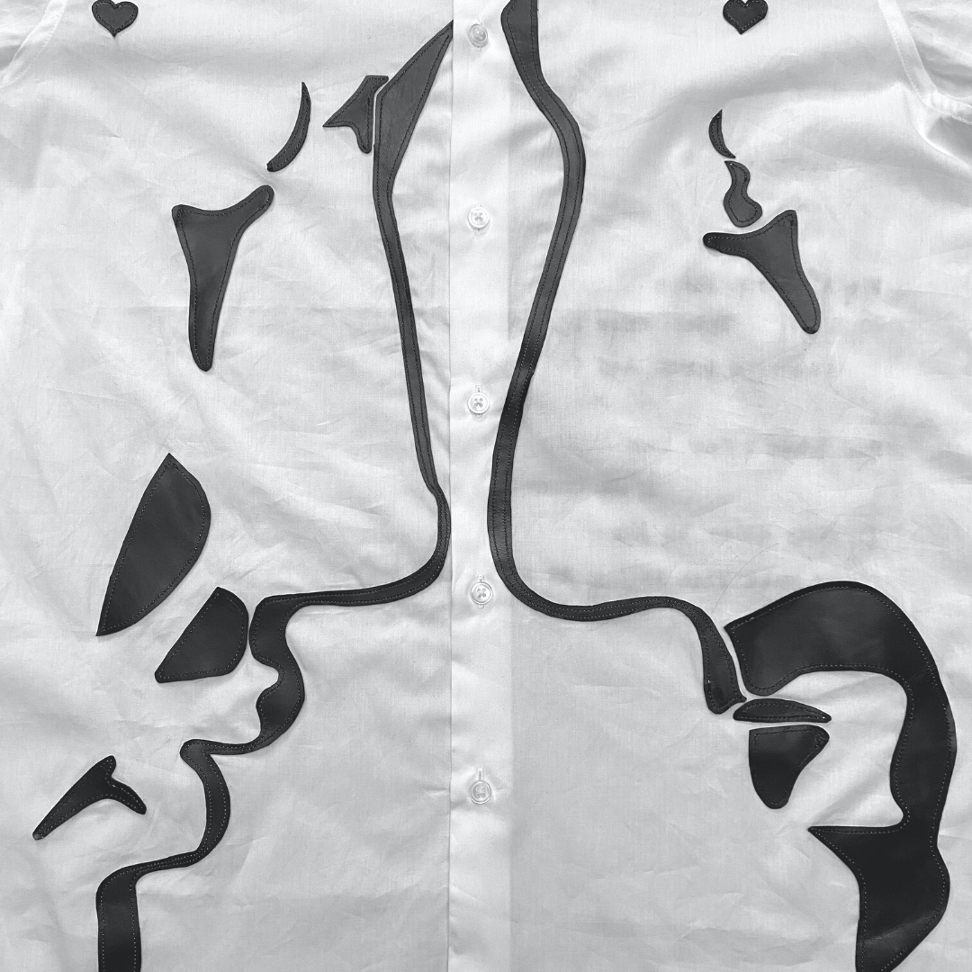 Unapologetic Youth button-down shirt featuring a faces pattern, showcased on a mannequin with long sleeves and a collar.