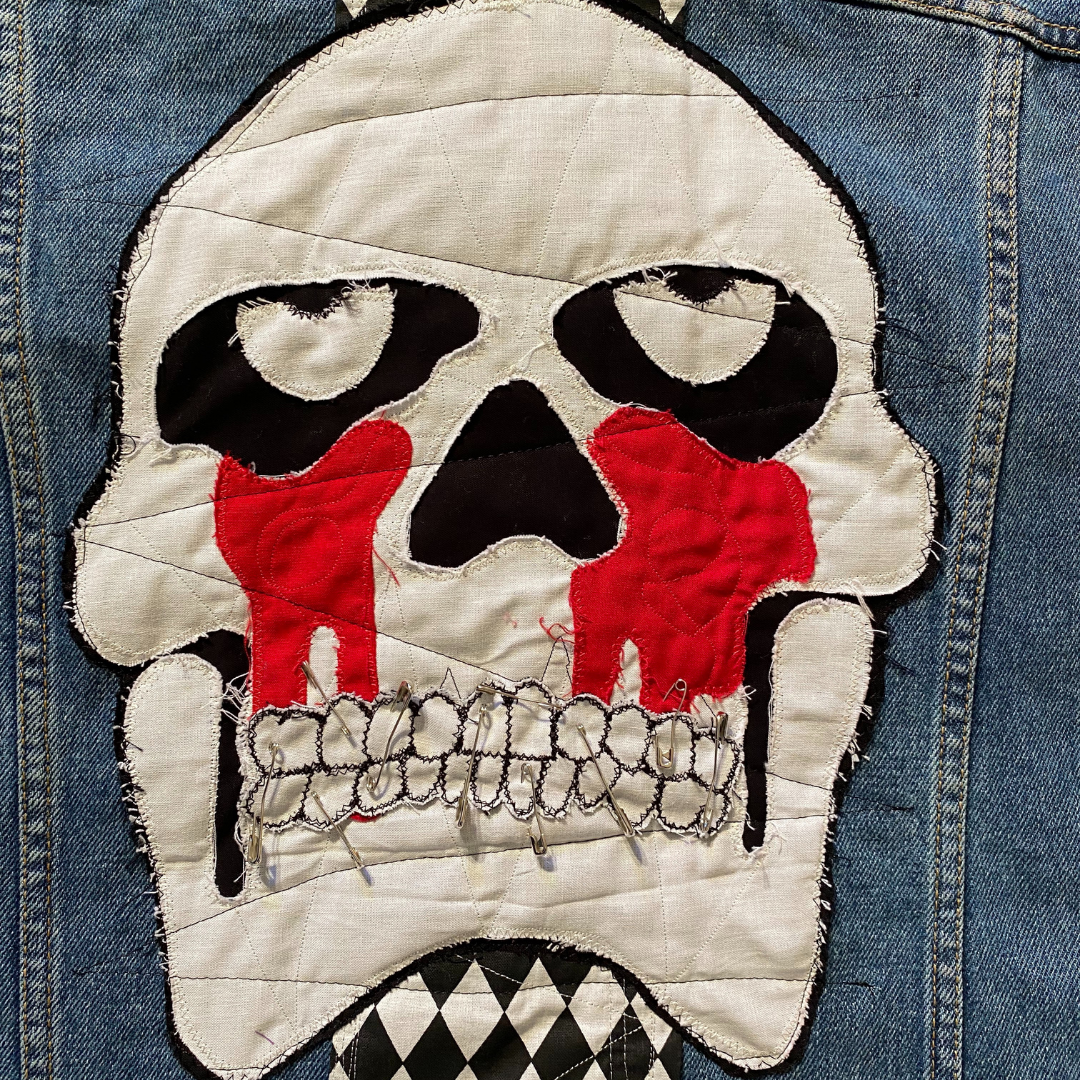 Unapologetic Youth Torn large/XL denim jacket with distressed details and classic fit, shown on a hanger.